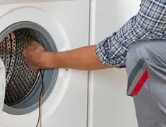 Dryer repair technician diagnosing and servicing a clothes dryer in Evansville, IN