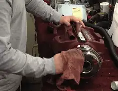 Vacuum repair technician cleaning and servicing a vacuum motor in Evansville, IN